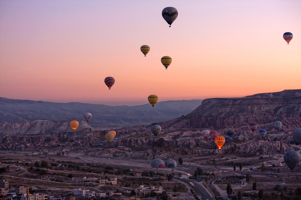 Hot-air balloons drifting over the valleys of Cappadocia at dawn